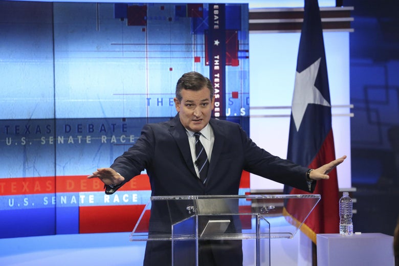 Ted Cruz stands behind a clear podium.